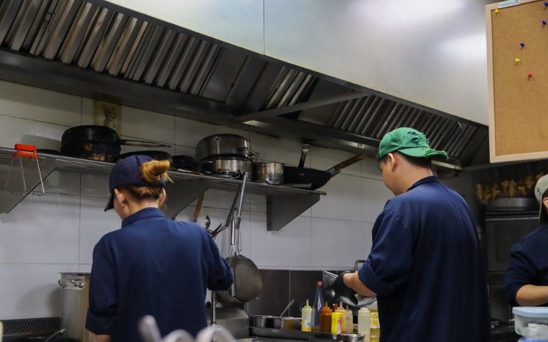 Madame Lam’s kitchen team carefully preparing dishes before service fine dining saigon