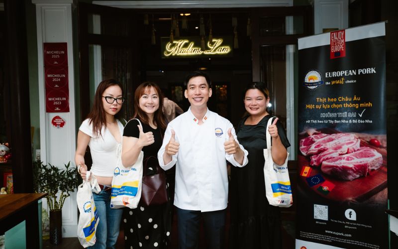 Madame Lam chef at a culinary event with guests